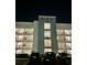 Apartment building featuring multiple floors with balconies and ample parking at 3180 Paradox Cir # 102, Kissimmee, FL 34746