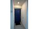 A navy blue front door with a black door mat sitting in front at 3180 Paradox Cir # 102, Kissimmee, FL 34746