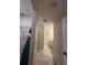 A long hallway with a closet on the left and bathroom on the right at 3180 Paradox Cir # 102, Kissimmee, FL 34746