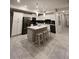 Modern kitchen featuring white cabinets, stainless steel appliances, and a center island with seating at 3180 Paradox Cir # 102, Kissimmee, FL 34746