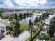 Community overview featuring a lake, lush landscaping, and building exteriors at 3719 Conroy Rd # 2023, Orlando, FL 32839