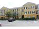 Attractive yellow apartment building featuring a well-maintained parking lot and landscaped surroundings at 3719 Conroy Rd # 2023, Orlando, FL 32839