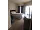 Carpeted bedroom features a queen bed, access to a balcony, and neutral decor at 3719 Conroy Rd # 2023, Orlando, FL 32839