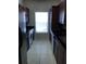 Bright kitchen with white tile floor, dark wood cabinets, stainless steel appliances and a large window at 3719 Conroy Rd # 2023, Orlando, FL 32839