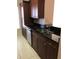 Close-up of kitchen with stainless steel sink, granite countertops, and modern cabinetry at 3719 Conroy Rd # 2023, Orlando, FL 32839