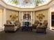 Elegant lobby with decorative glass ceiling, fireplace, sofas, and comfortable seating at 3719 Conroy Rd # 2023, Orlando, FL 32839