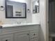 Bathroom with white vanity, black mirror, and shower/tub combo at 4149 S Semoran Blvd # 10, Orlando, FL 32822