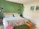 Spacious bedroom with a king-size bed and green accent wall at 4149 S Semoran Blvd # 10, Orlando, FL 32822