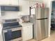 Stainless steel appliances and white cabinetry in kitchen at 4149 S Semoran Blvd # 10, Orlando, FL 32822