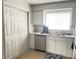 White kitchen with stainless steel appliances and pantry at 4149 S Semoran Blvd # 10, Orlando, FL 32822