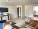 Bright living room with brown leather sectional sofa and TV at 4149 S Semoran Blvd # 10, Orlando, FL 32822