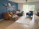 Living room with sectional sofa, accent chair, and access to balcony at 4149 S Semoran Blvd # 10, Orlando, FL 32822