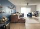 Living room with sectional sofa, accent chair, and access to balcony at 4149 S Semoran Blvd # 10, Orlando, FL 32822