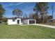 Newly built home with a white exterior, black accents, and a grassy lawn at 4411 Sw 132Nd Pl, Ocala, FL 34473
