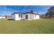White house with covered patio and grassy yard at 4690 Sw 139Th Place, Ocala, FL 34473