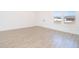 Bright living room featuring tile flooring and large window at 4690 Sw 139Th Place, Ocala, FL 34473