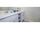 Double vanity bathroom with white cabinets and quartz countertop at 4731 Clock Tower Dr # 206, Kissimmee, FL 34746