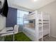 Bedroom with bunk beds, desk, and green rug at 4731 Clock Tower Dr # 206, Kissimmee, FL 34746