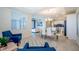 Open dining room with glass table and blue chairs at 4731 Clock Tower Dr # 206, Kissimmee, FL 34746