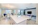 Modern kitchen with island, stainless steel appliances, and breakfast bar at 4731 Clock Tower Dr # 206, Kissimmee, FL 34746