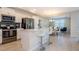 Modern kitchen with white cabinets, island, and stainless steel appliances at 4731 Clock Tower Dr # 206, Kissimmee, FL 34746