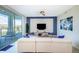 Bright living room with white sectional sofa, large TV, and balcony access at 4731 Clock Tower Dr # 206, Kissimmee, FL 34746