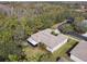 Single-story home with screened porch, situated on a wooded lot at 554 Heartwell Dr, Kissimmee, FL 34759