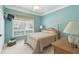 Cozy bedroom featuring a full-size bed and window at 554 Heartwell Dr, Kissimmee, FL 34759