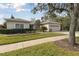 One-story house with a two-car garage and manicured lawn at 554 Heartwell Dr, Kissimmee, FL 34759