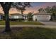 One-story house with landscaped yard and two-car garage at 554 Heartwell Dr, Kissimmee, FL 34759