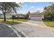 Single-story home with a paved driveway and landscaping at 554 Heartwell Dr, Kissimmee, FL 34759