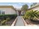 Welcoming front entry with a brick walkway and lush landscaping at 554 Heartwell Dr, Kissimmee, FL 34759