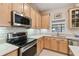 Modern kitchen with stainless steel appliances and white tile at 554 Heartwell Dr, Kissimmee, FL 34759