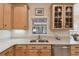 Modern kitchen with stainless steel sink, light wood cabinets and granite countertops at 554 Heartwell Dr, Kissimmee, FL 34759
