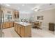 Kitchen boasts an island, stainless steel appliances, and light wood cabinets at 554 Heartwell Dr, Kissimmee, FL 34759
