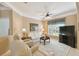 Bright living room featuring comfy seating and a large TV at 554 Heartwell Dr, Kissimmee, FL 34759