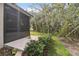Screened porch overlooking a tranquil backyard and wooded area at 554 Heartwell Dr, Kissimmee, FL 34759