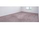 Simple bedroom with neutral carpeting and a window at 566 Pawnee Ct, Haines City, FL 33844