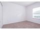 Simple bedroom with neutral carpeting and a window at 566 Pawnee Ct, Haines City, FL 33844