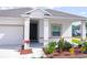 Single story home with landscaped yard and driveway at 566 Pawnee Ct, Haines City, FL 33844