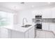 White kitchen with island, stainless steel appliances, and breakfast nook at 566 Pawnee Ct, Haines City, FL 33844