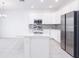 Modern kitchen with white cabinets, stainless steel appliances, and an island at 566 Pawnee Ct, Haines City, FL 33844