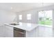 White quartz kitchen island with double sink and dishwasher at 566 Pawnee Ct, Haines City, FL 33844