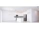 Bright kitchen featuring white cabinets, stainless steel appliances, and an island at 566 Pawnee Ct, Haines City, FL 33844
