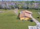 Aerial view of a ranch-style home situated on a spacious lot with a large yard at 713 Green Ct, Kissimmee, FL 34759