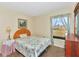 Bedroom with a floral-print bedspread and large window at 713 Green Ct, Kissimmee, FL 34759