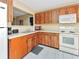 Kitchen with wood cabinets and white appliances at 713 Green Ct, Kissimmee, FL 34759