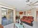 Living room with access to screened porch and dining area at 713 Green Ct, Kissimmee, FL 34759