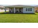 Covered patio with seating area and grassy lawn at 742 San Joaquin Rd, Kissimmee, FL 34759