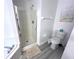 Bathroom with shower stall, toilet, and grey flooring at 8417 Secret Key Cove, Kissimmee, FL 34747